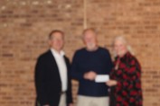 ken Koehler and Amy Lawler presenting a check to St. Vince DePaul